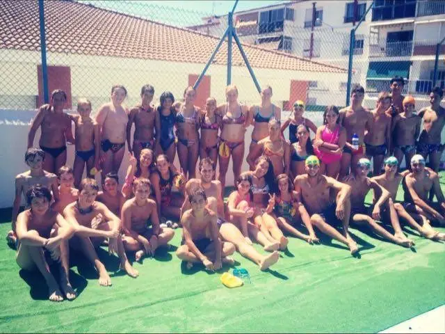 Club Natación Axarquía swimmers gathered beside the pool