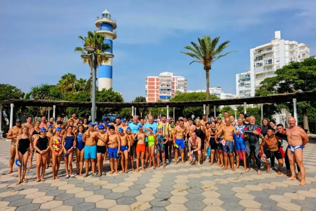 Swimmers and families by the Torre del Mar lighthouse at the club’s Pepe Fajardo swim